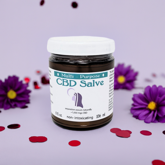12 x 8oz - CBD Topical Salve (~1,000 mg CBD) in a brown jar with white lid surrounded by purple flowers and red confetti.