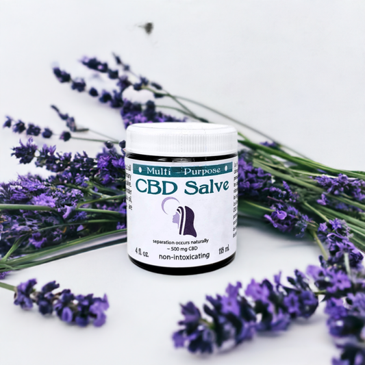 12 x 4oz - CBD Topical Salve (500 mg CBD/Jar) jar surrounded by fresh lavender flowers on white background.