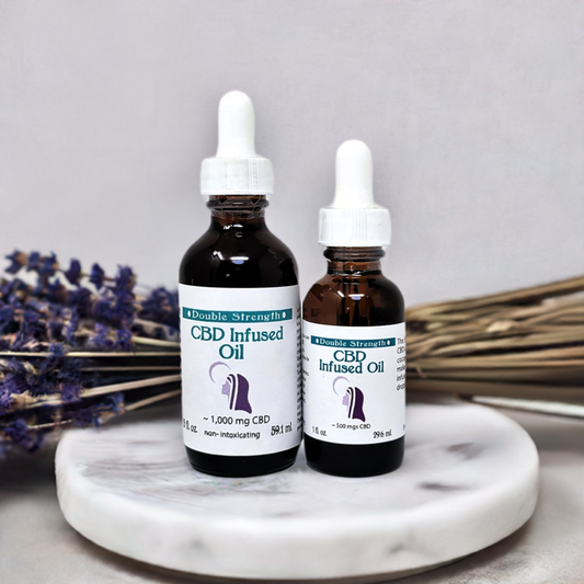 12 x CBD Infused Oil Double Strength two sizes with droppers on white marble plate with lavender background